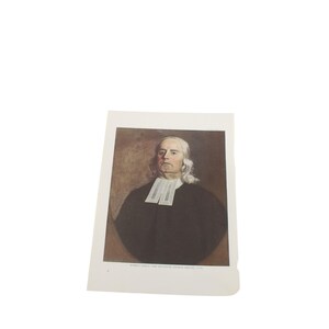 Op de afbeelding: Een portretprint van een man met lang wit haar en een witte kraag. De man draagt een zwarte toga. De print staat op een witte achtergrond. De tekst onderaan de print luidt "ROBERT ISAAC THE REVEREND GEORGE WHITE".
