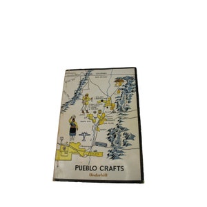 May include: A vintage book cover with a map of Pueblo Indian villages in New Mexico. The cover is yellow and white with a blue and white illustration of mountains. The title of the book is "Pueblo Crafts" by Underhill.