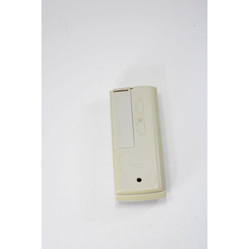 May include: A white remote control with the text "AUTOMATIC LIGHT" and "ON/OFF" printed on it.