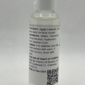 May include: A clear liquid product in a small, white-capped bottle. The label includes instructions and ingredients, such as water, glycerin, and hyaluronic acid. The bottle is labeled "Made in the USA."