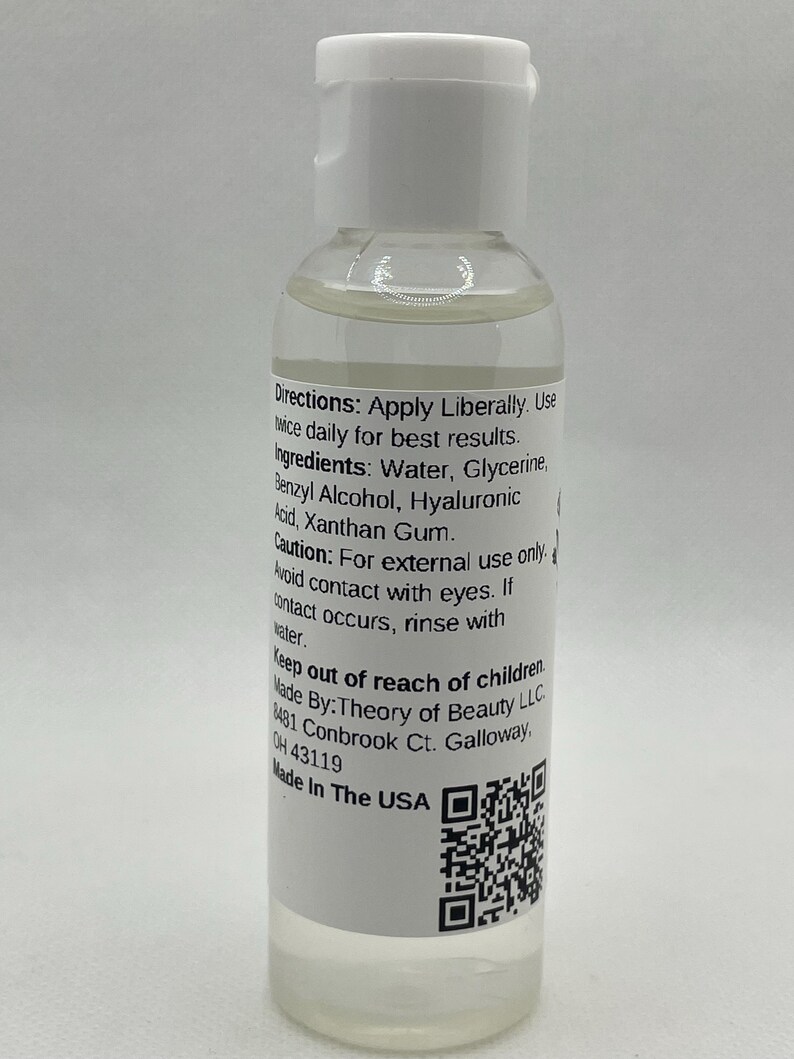 May include: A clear liquid product in a small, white-capped bottle. The label includes instructions and ingredients, such as water, glycerin, and hyaluronic acid. The bottle is labeled "Made in the USA."