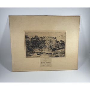 May include: An original etching by James McCol, titled "On the Doon, Ayr." The artwork depicts a landscape scene with trees, water, and a small boat. The etching is framed in a cream-colored mat.