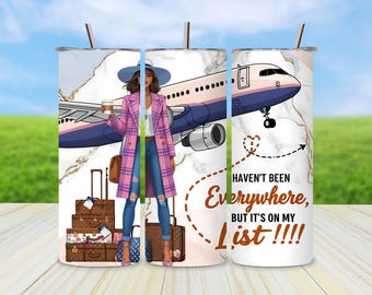 May include: A travel-themed tumbler featuring a woman in a pink plaid coat, jeans, and a hat, holding a coffee cup. The design includes an airplane, luggage, and the text "Haven't Been Everywhere, But It's On My List!!!!"