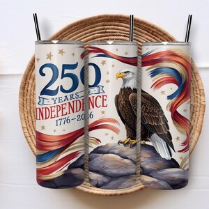 May include: Three stainless steel tumblers with black straws. The design celebrates 250 Years of Independence, featuring an eagle and patriotic colours. The tumblers are decorated with the text "250 Years of Independence 1776-2016".