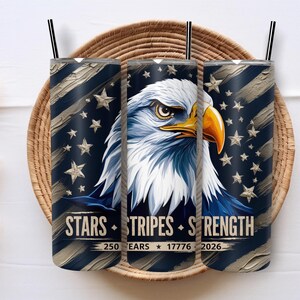 May include: Three stainless steel tumblers with black straws, featuring a patriotic design. The design includes an eagle, stars, and stripes, with the words "Stars, Stripes, Strength" and the numbers 250, 17776, and 2026.
