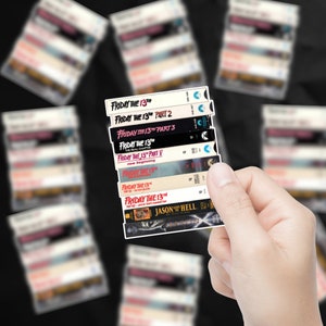 May include: A stack of VHS tapes featuring the horror movie franchise "Friday the 13th". The tapes are arranged in order of release, starting with the first film and ending with "Jason Goes to Hell: The Final Friday".