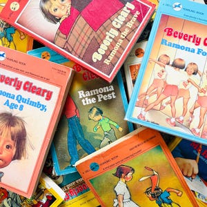 May include: A collection of vintage Dell Yearling paperback books by Beverly Cleary, including titles such as Ramona the Brave, Ramona Forever, Ramona Quimby, Age 8, and Ramona the Pest, featuring colorful illustrated covers with various character scenes.