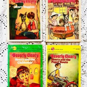 May include: Four vintage Dell Yearling paperback books by Beverly Cleary. Titles include Henry Huggins, Henry and the Clubhouse, and Henry and the Paper Route. Each cover features colorful illustrations of characters, a dog, and various scenes.