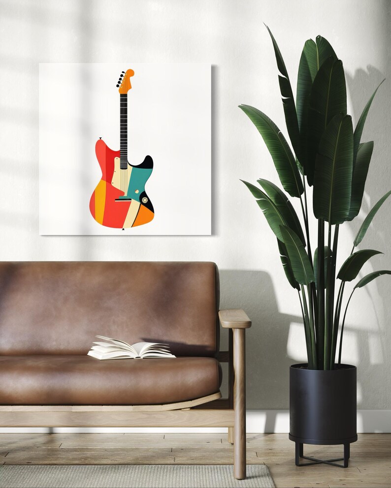 Może przedstawiać: Kolorowy, abstrakcyjny nadruk z gitarą na białym pł&oacute;tnie. Gitara ma czerwone, pomarańczowe, ż&oacute;łte, niebieskie i czarne geometryczne kształty. Grafika jest wyświetlana nad brązową sk&oacute;rzaną sofą z otwartą książką, obok rośliny doniczkowej.