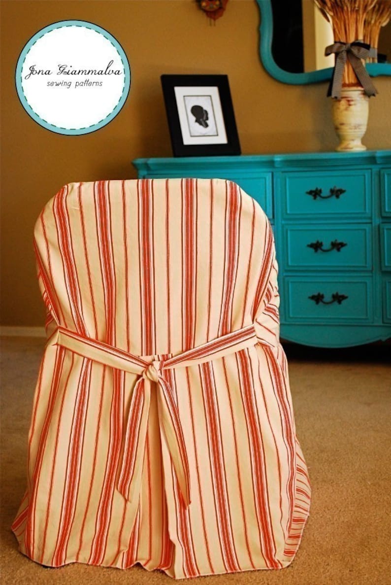 May include: Chair cover with a cream and red striped pattern. The cover is tied at the back with a matching fabric tie. The chair cover is part of a sewing pattern collection.