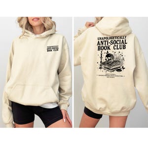 The image is a collage of two photos of a woman wearing a beige hoodie with text and graphics printed on it.