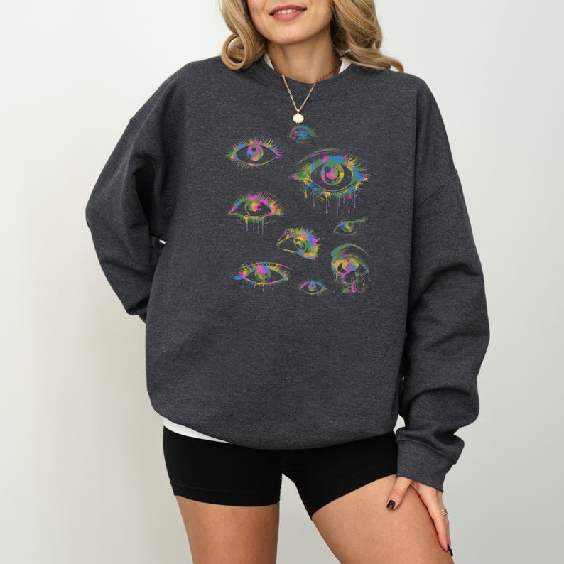 a woman wearing a sweatshirt with an eye print on it