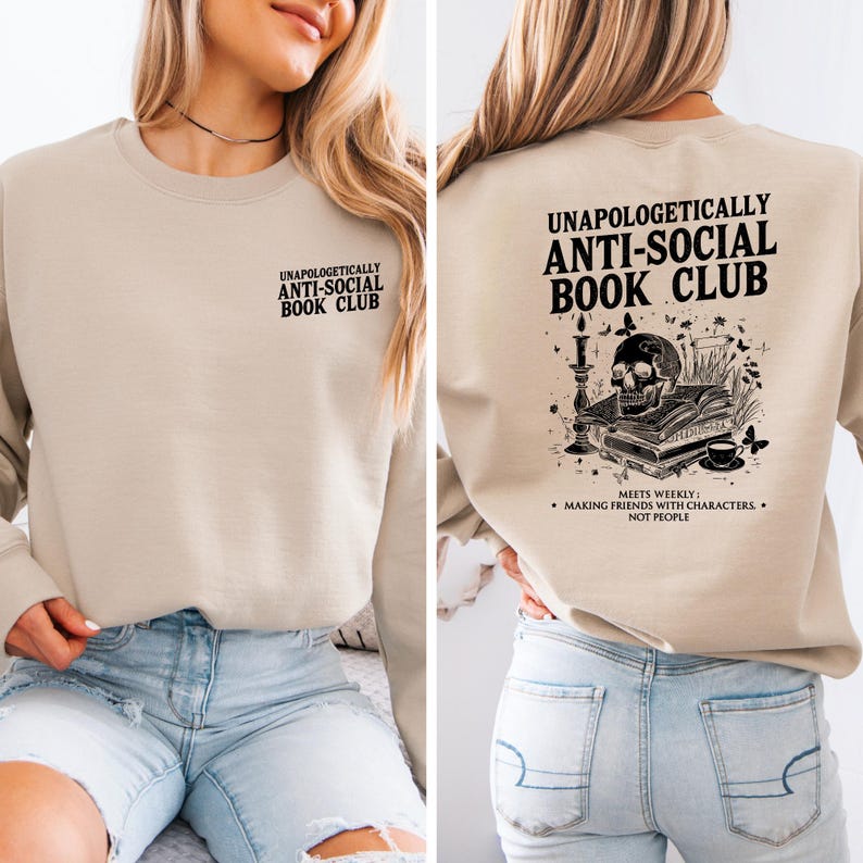 a woman wearing a beige sweatshirt with text and graphics on the back.