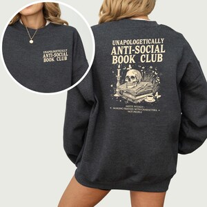 a gray sweatshirt with text and an illustration on the back.