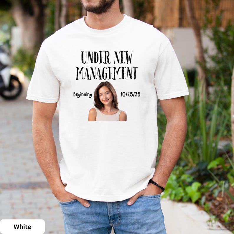 a man wearing a white t - shirt with a picture of a woman on it