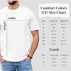 a man wearing a white t - shirt with a size chart