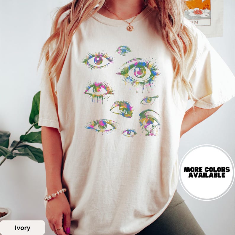 a woman wearing a t - shirt with an eye print on it