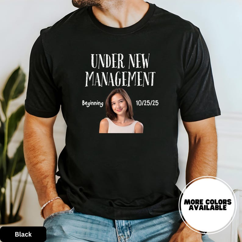 a man wearing a black t - shirt with a picture of a woman