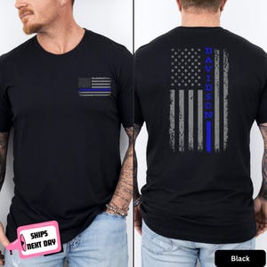 May include: Black crew neck t-shirt with a distressed American flag design. The front features a small flag with a blue line, while the back displays a larger flag with the word "DAVIDSON" and a blue line. The shirt is made of a soft material.
