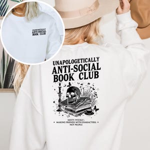 The image is a collage of two images. The collage shows a person wearing a white sweater with a graphic design on the back, and another image of a person's back with a white hat.