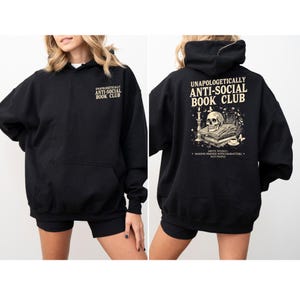 A black hoodie with text and an illustration on the back.