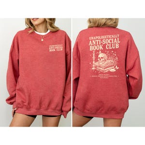 A red sweatshirt with text and graphics on the back.