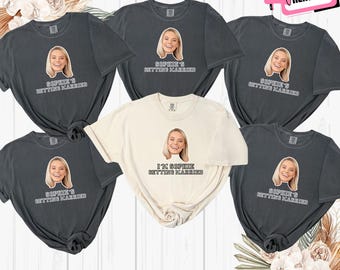May include: Six gray and ivory t-shirts with a photo of a woman and the text "Sophie's Getting Married" or "I'm Sophie Getting Married".