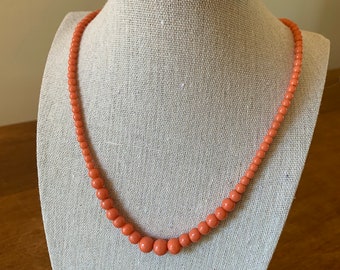 Vintage coral colored plastic beaded necklace with gold tone toggle clasp, excellent project to rethread or reuse beads