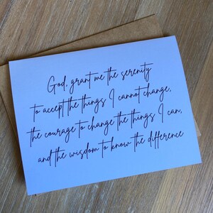 May include: A white rectangular greeting card featuring black cursive text that reads: God, grant me the serenity to accept the things I cannot change, the courage to change the things I can, and the wisdom to know the difference. A brown envelope is included.