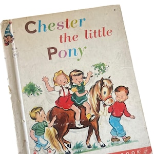 May include: Vintage children's book titled "Chester the Little Pony." The cover features an illustration of children riding a pony. The book has a light-colored cover with the text "A Rand McNally Elf Book."