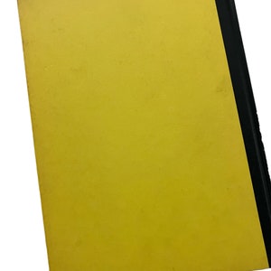 May include: A yellow hardback book with a black spine.