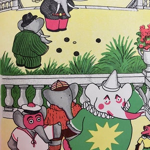May include: A group of grey elephants wearing different costumes are playing a game of marbles in a garden setting. One elephant is wearing a clown costume with a green and yellow star on the front. Another elephant is wearing a sailor costume with a red and white striped shirt and a red hat. A third elephant is wearing a red and orange jumper and a brown hat. The elephants are playing on a yellow surface with green grass and a white fence in the background.
