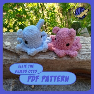 Puede incluir: Dos pulpos de peluche, uno azul claro y otro rosa, están sobre una superficie de madera. Los pulpos tienen ojos grandes y aletas en forma de orejas. El texto en una pancarta azul dice "Ellie the Dumbo Octo PDF Pattern."