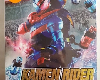 May include: A DVD box set featuring the Japanese superhero Kamen Rider Build. The box art features the character in a blue and red suit with a golden helmet. The text on the box reads "Kamen Rider Build" in Japanese and English, and "Vol. 1-49 End + 4 Movie".