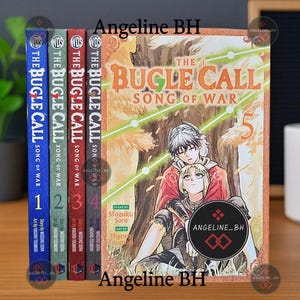 May include: A collection of five manga books titled "The Bugle Call Song of War." The spines are blue, green, red, and dark red, with the fifth book featuring a cover illustration of two characters. The books are displayed on a wooden surface.