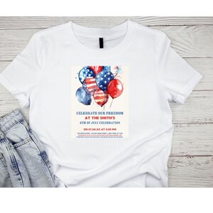 May include: White t-shirt with a watercolor design of red, white, and blue balloons. The balloons are decorated with stars and stripes. The text on the shirt reads: "Celebrate our freedom at the Smith's 4th of July celebration on 07.04.XX at 5:00 PM".