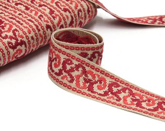 May include: A beige and red embroidered trim with a repeating pattern of stylized floral designs. The trim is woven and has a subtle sheen.