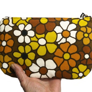 large 70s retro pouch with zipper with flowers in yellow and white on dark brown. 
Handmade from genuine vintage fabrics. 
25 cm wide and 16 cm high. 
Perfect for makeup, pencils, and everything you want to store in it. 
Made in The Netherlands