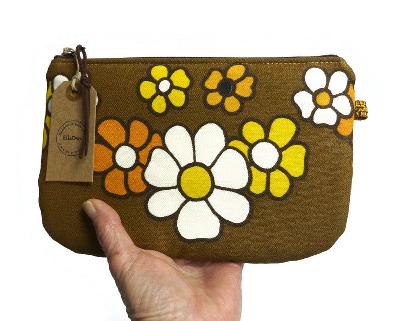 large 70s retro pouch with zipper with flowers in yellow and white on dark brown. 
Handmade from genuine vintage fabrics. 
25 cm wide and 16 cm high. 
Perfect for makeup, pencils, and everything you want to store in it. 
Made in The Netherlands