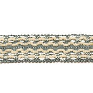May include: A close-up of a gray and beige trim with a repeating pattern of woven loops and silver accents.