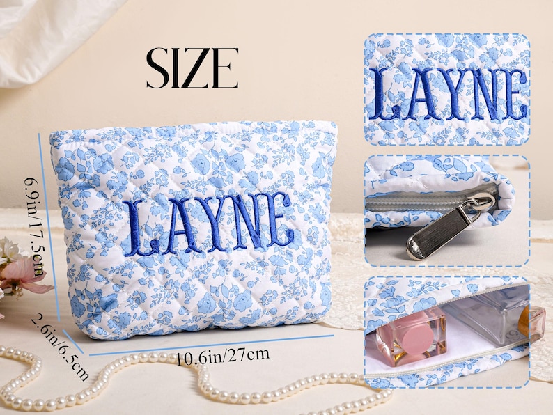May include: A quilted cosmetic bag with a blue floral pattern and the name "LAYNE" embroidered in blue. The bag is 10.6 inches long, 6.9 inches high, and 2.6 inches wide. It has a zipper closure and is designed to hold makeup and other beauty products.