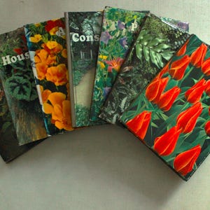 May include: A collection of vintage gardening books with colorful floral covers. Titles include "Flower House" and "Bulbs." The books feature images of flowers, plants, and foliage, with a focus on gardening and horticulture.