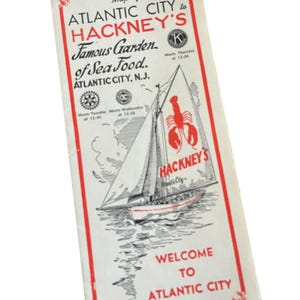 May include: Vintage map of Atlantic City to Florida, featuring a red and white design. The map highlights Hackney's Famous Garden of Sea Food, with a sailboat illustration and the text "Welcome to Atlantic City."