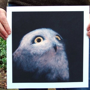 May include: A close-up of a white owl with large, dark eyes, painted on a black background. The owl is looking up and to the right, with its head tilted slightly. The painting is framed in a white mat.