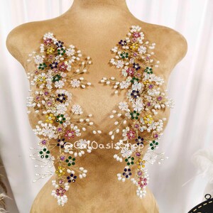 May include: Two symmetrical floral appliques crafted from gold wire, featuring white pearl-like beads and multi-colored crystals in pink, yellow, green, and blue. The text "@CatOasisShop" is visible in the center of the two decorative pieces.