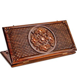 May include: A wooden backgammon board with a woven pattern and a decorative, circular, floral design in the center. The board is a rich brown color with a hinged design for easy storage and transport.