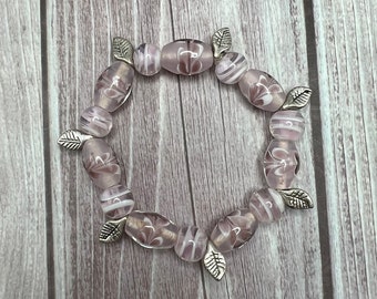 Pastel pink lamp work beaded stretch bracelet with silver leaf accents