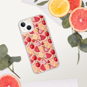 May include: A clear phone case with a pink background and a pattern of watermelon, strawberries, lemons, and tomatoes.