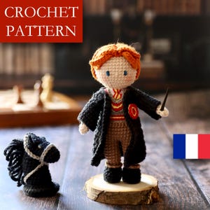 May include: A crocheted doll of a character with red hair, wearing a black robe and holding a wand. The doll is standing on a wooden slice. A black crocheted horse is to the left. The text "CROCHET PATTERN" is at the top.
