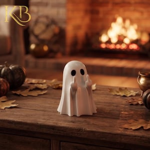 May include: A white ghost figurine with two black oval eyes, depicted with both arms raised and middle fingers extended. The smooth, matte-finished ghost stands upright, featuring a classic draped sheet shape with rounded edges and a simple, minimalist form.